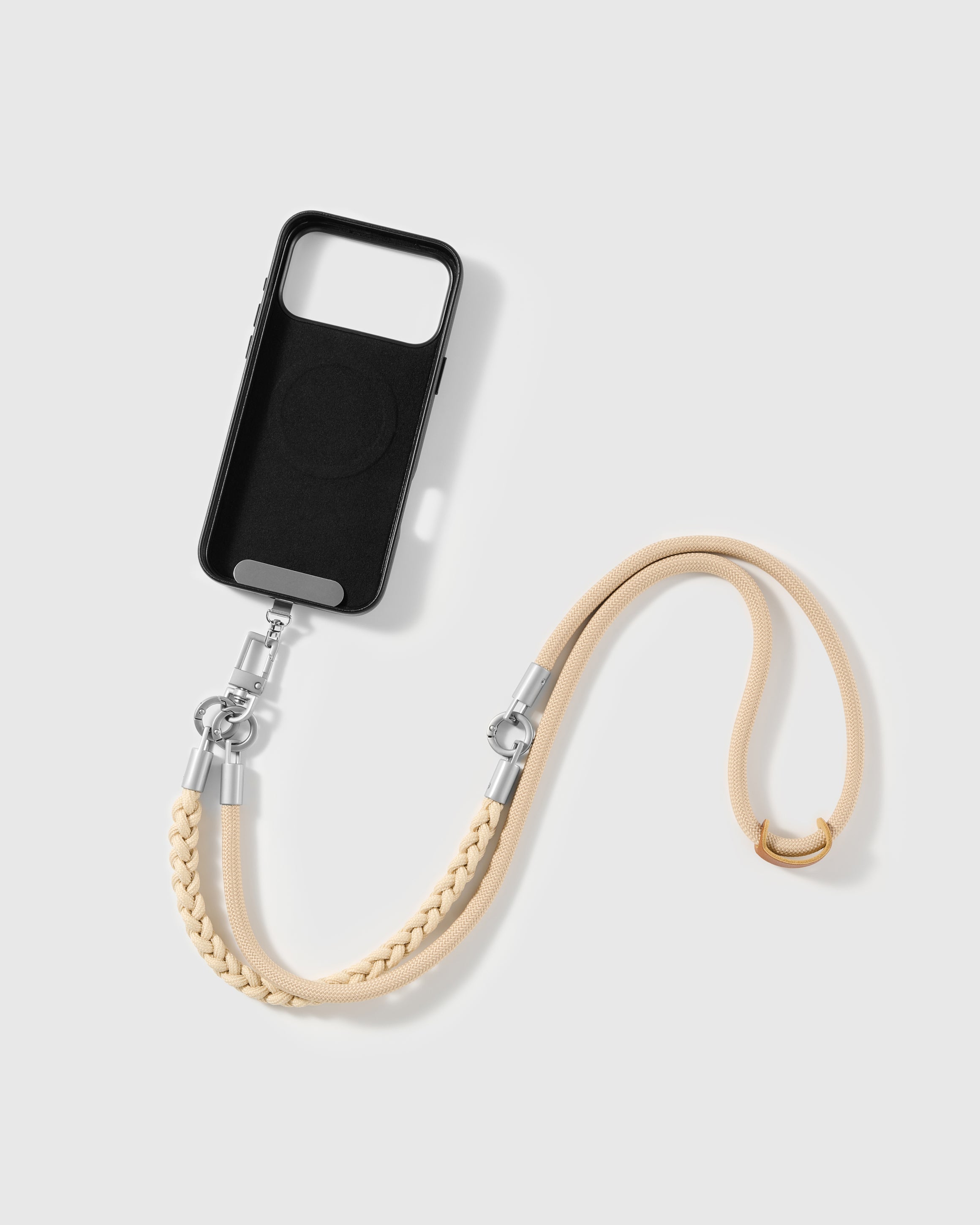 Phone worn cross-body on the sand braided strap, hands-free for everyday carry