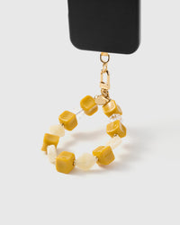 Saffron yellow bead phone strap hanging from black phone case showing wrist carry