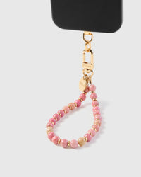 Rose stone phone strap hanging from black phone case in wrist-carry position