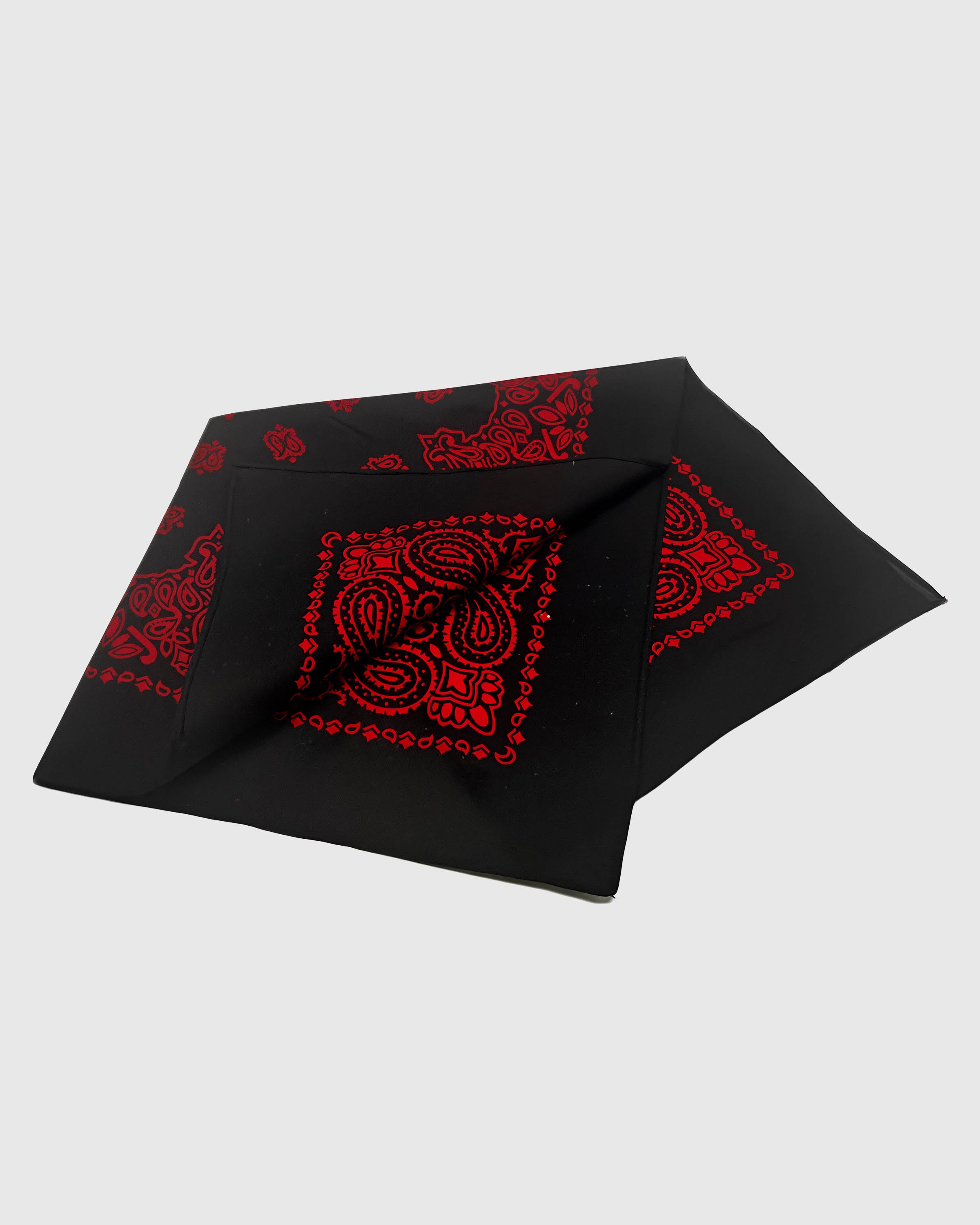 Black silk bandana scarf opened to show the crimson paisley medallion and scalloped border