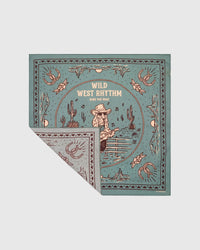 Sage silk scarf with a folded corner showing the soft reverse and the printed western field