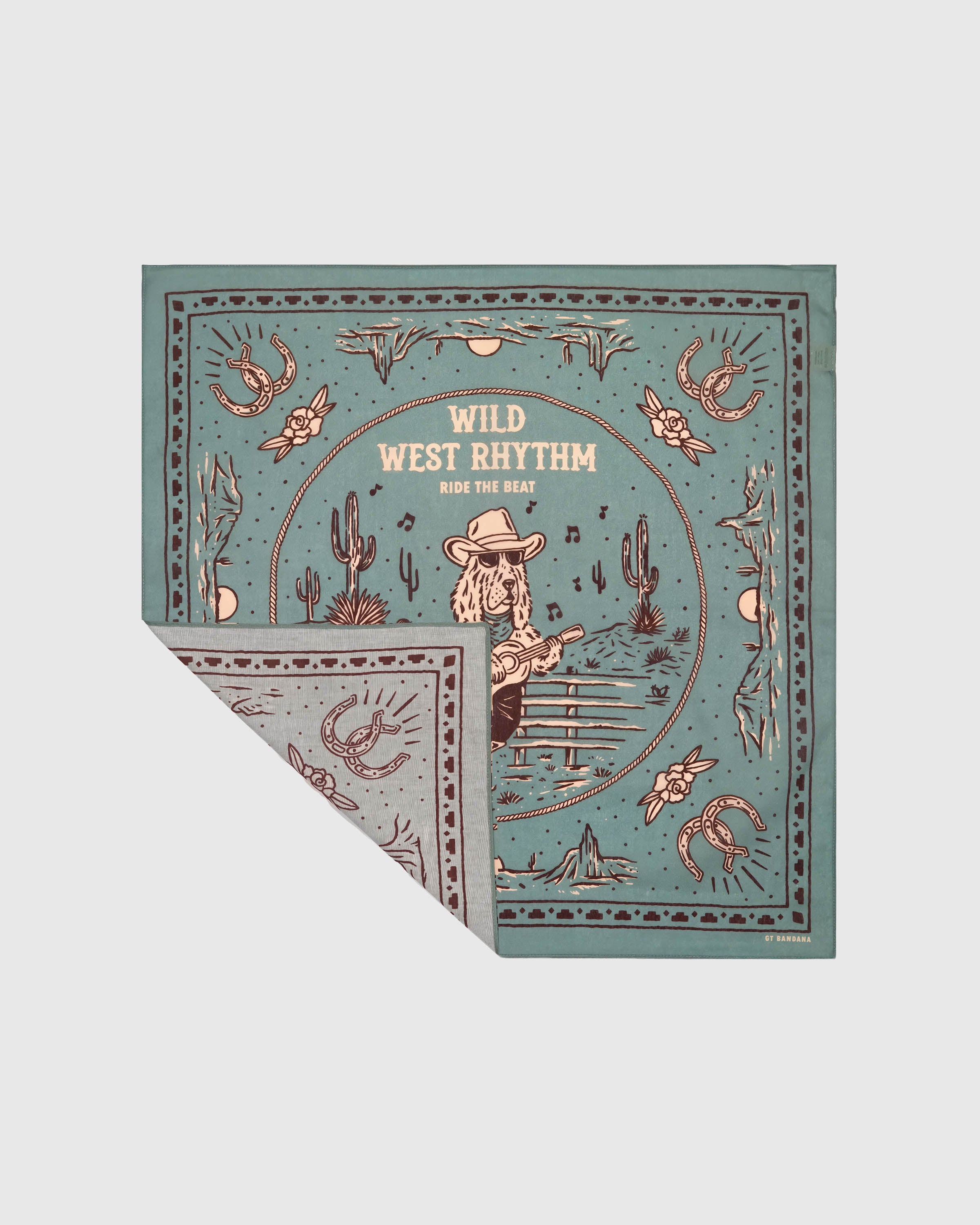 Sage silk scarf with a folded corner showing the soft reverse and the printed western field