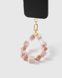 Rose marble bead phone strap hanging from black phone case showing wrist carry functionality