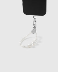 Close-up of pearlescent beads and oversized pearl heart accents showing soft glow