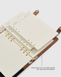 Close-up of the six-hole A5 inserts clipping onto a gold six-ring mechanism, showing how quickly the pages refill.