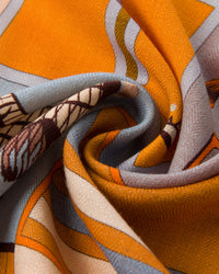 Horse blanket patchwork silk scarf with twelve saddled horses across orange, saffron, blush, and sage panels
```