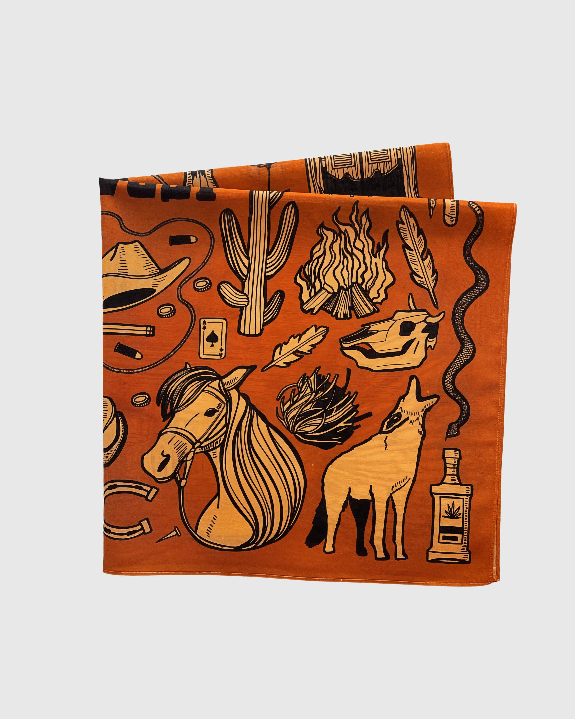 Cognac silk scarf folded to show the horse, coyote and campfire vignettes printed on the silk