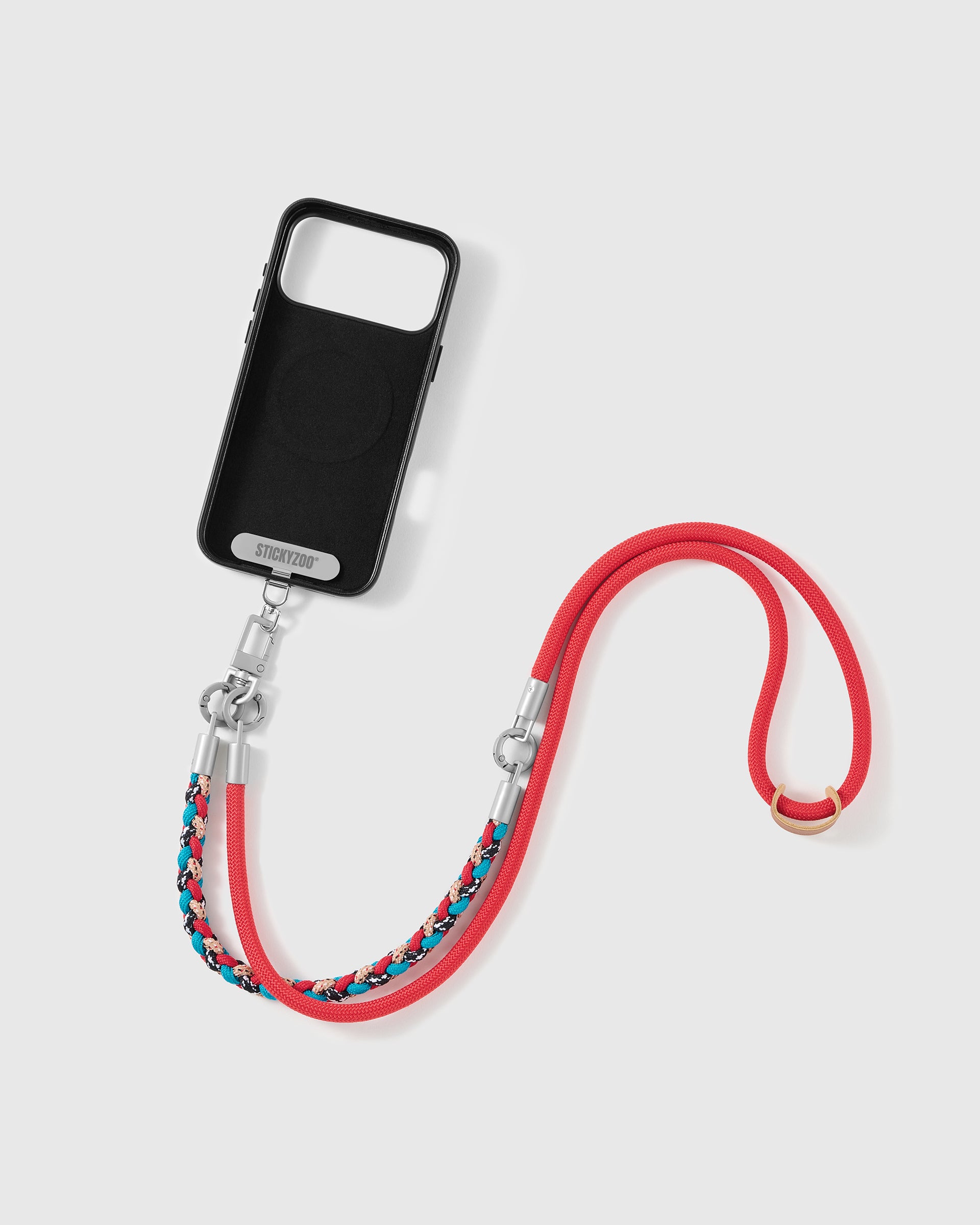 Phone worn cross-body on the scarlet braided strap, hands-free for everyday carry