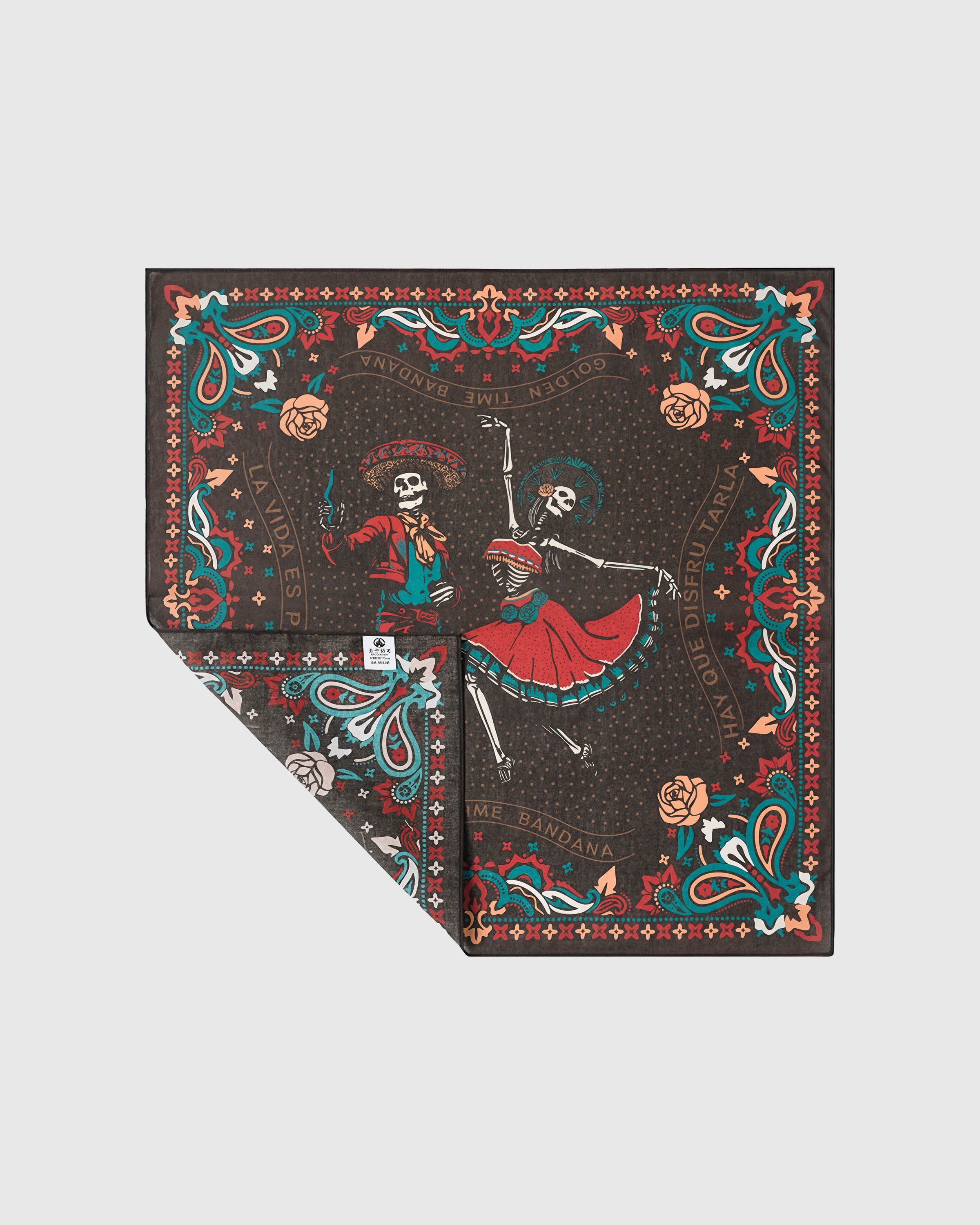 Silk calavera scarf folded to show the teal and red paisley border on the charcoal field