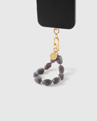 Storm agate phone strap hanging from black phone case showing wrist carry functionality
