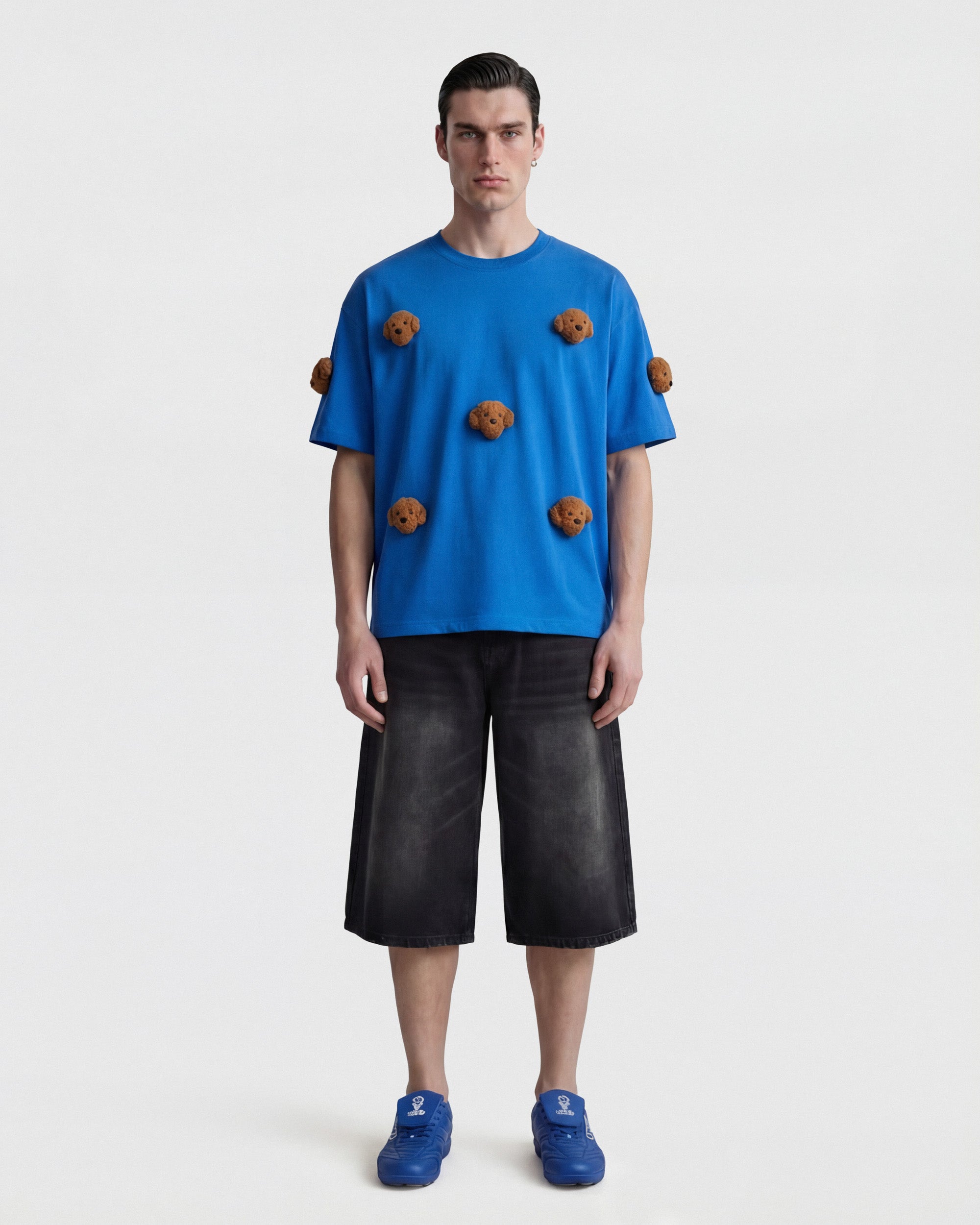 {{Model is wearing size XL}} Model wearing STICKYZOO Poodle Parade T-Shirt in blue showing dropped shoulders and plush poodles