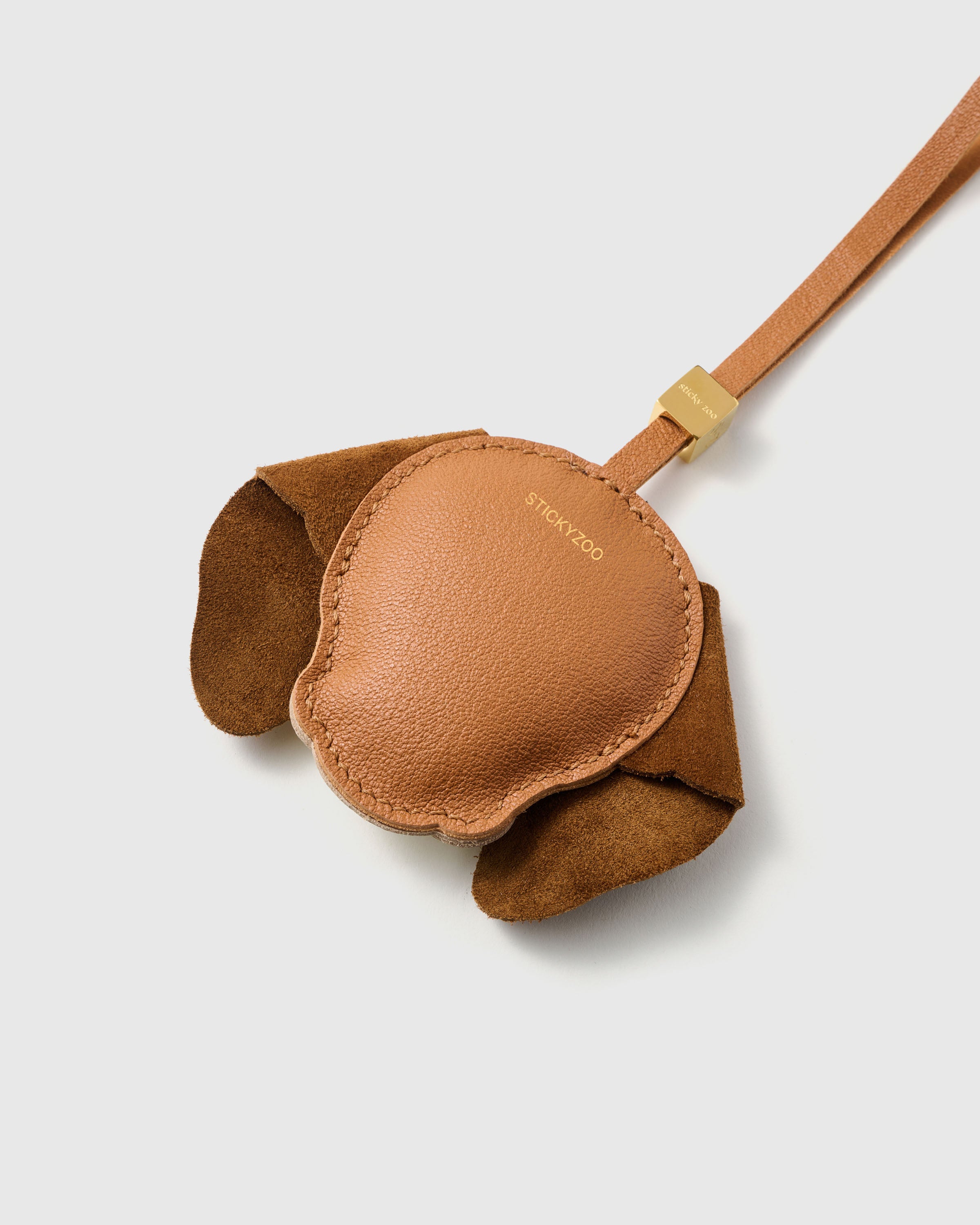 {{Finished on both sides.}} smooth French Alran goatskin back with gold STICKYZOO embossing — alcantara suede ears, 18K gold-plated hardware. No shortcuts, even where you can't see.