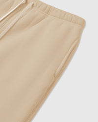 Detail of elastic waistband and cream drawstring on premium cotton sweatpants showing fabric density and construction