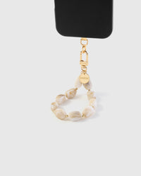 STICKYZOO Ivory Marble phone strap attached to black phone case showing warm cream stone beads