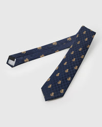 Raised thread, not print Atlas Bear Tie knot close-up showing embroidered teddy bear detail on navy geometric silk