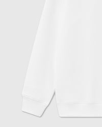 Model wearing STICKYZOO Dachshund Apple Sweatshirt in white showing dropped shoulders and relaxed silhouette