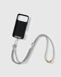 Phone worn cross-body on the pewter braided strap, hands-free for everyday carry