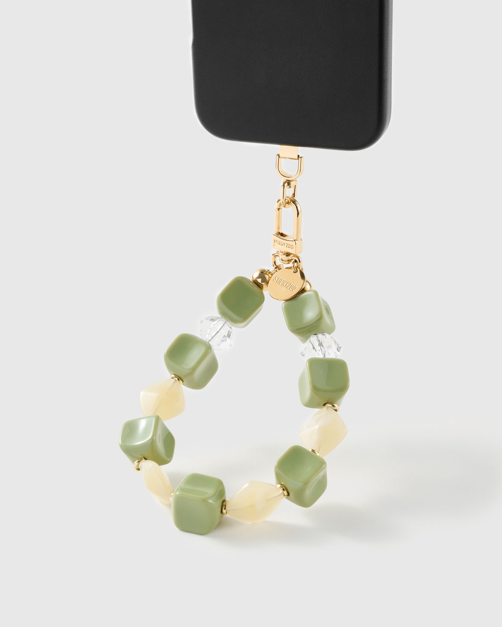 Matcha marbled bead wrist strap clipped to a black phone case for hands-free carry
