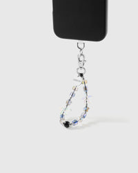 Aurora Starfish beaded strap hanging from a black phone case by its silver clasp, with the engraved STICKYZOO disc and a glossy black bead