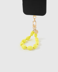 Close-up of neon yellow oval beads and gold-plated engraved STICKYZOO clasp and charm disc