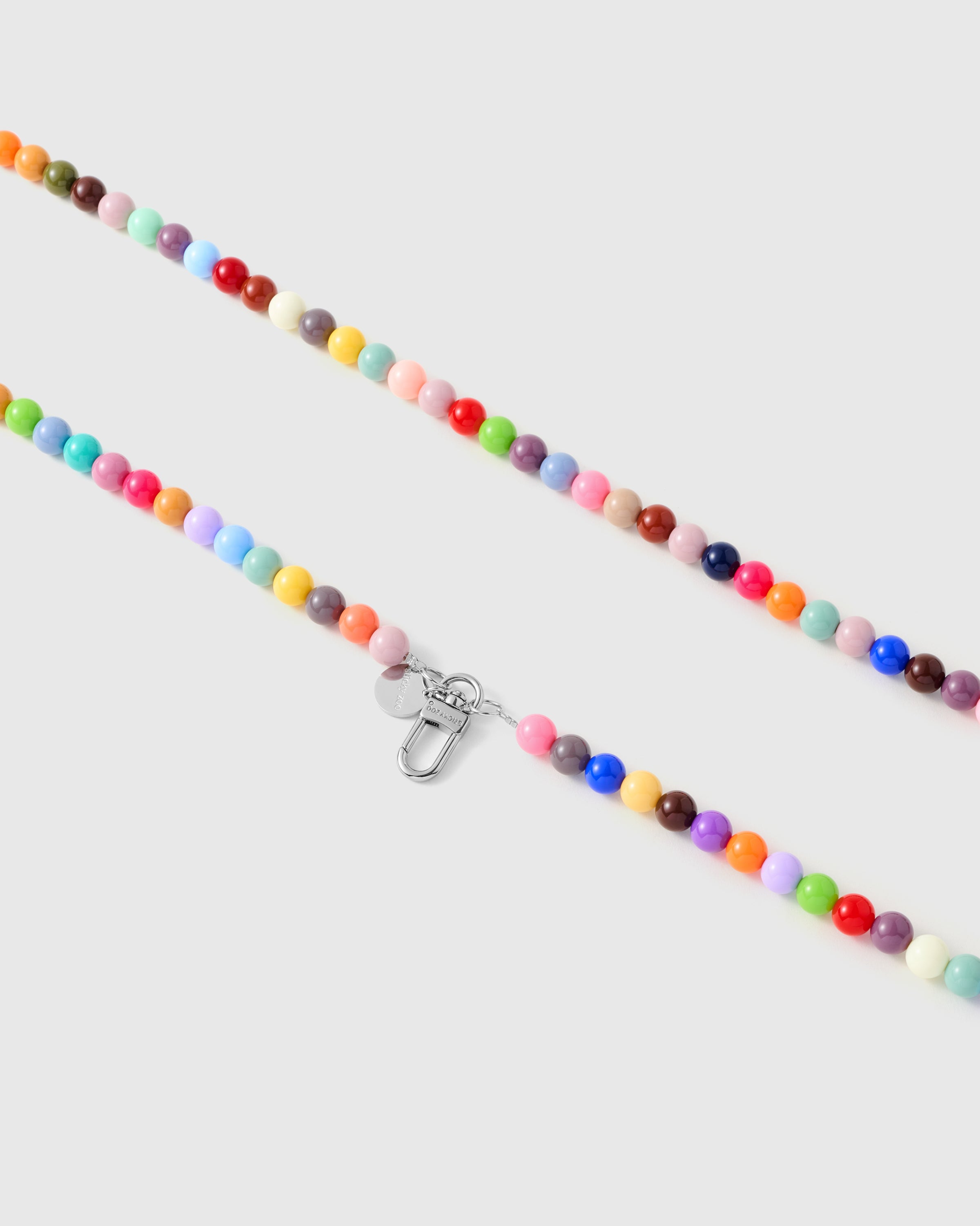 Silver-tone lobster clasp and engraved STICKYZOO charm disc on a handmade beaded cross-body phone strap.