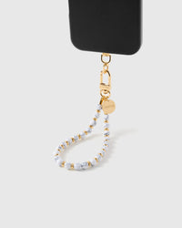 Close-up of white marble stone beads showing natural grey veining and gold spacers