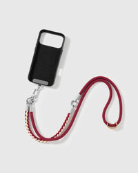 STICKYZOO cross-body phone strap laid flat beside a phone case it attaches to