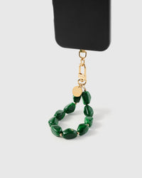Emerald marble stone phone strap hanging from black phone case showing wrist carry