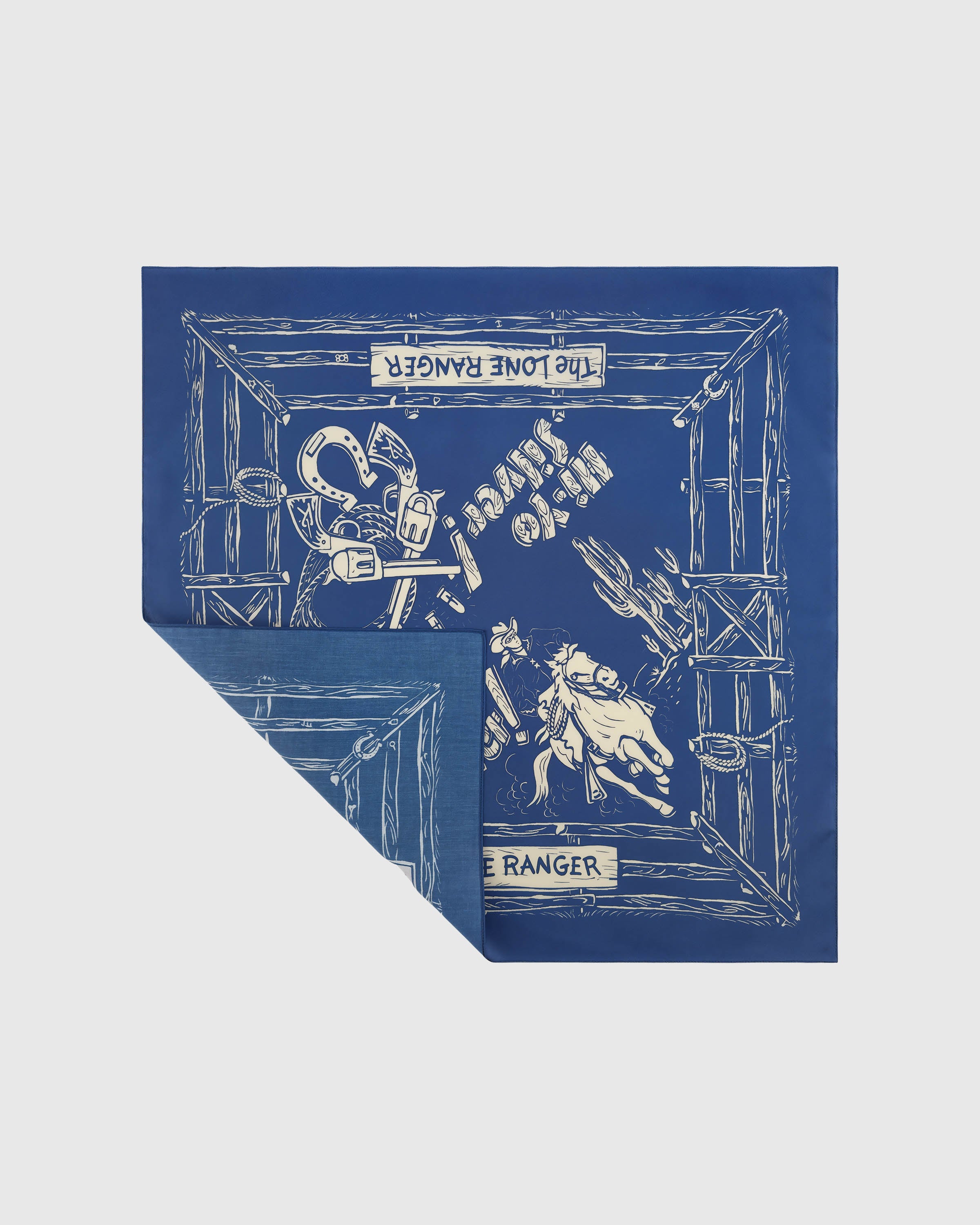 Cobalt silk cowboy scarf opened to show the galloping rider and ivory corral frame on pure silk