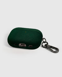 Back view of forest green Alcantara case showing USB-C port, speaker cutouts, and metal carabiner