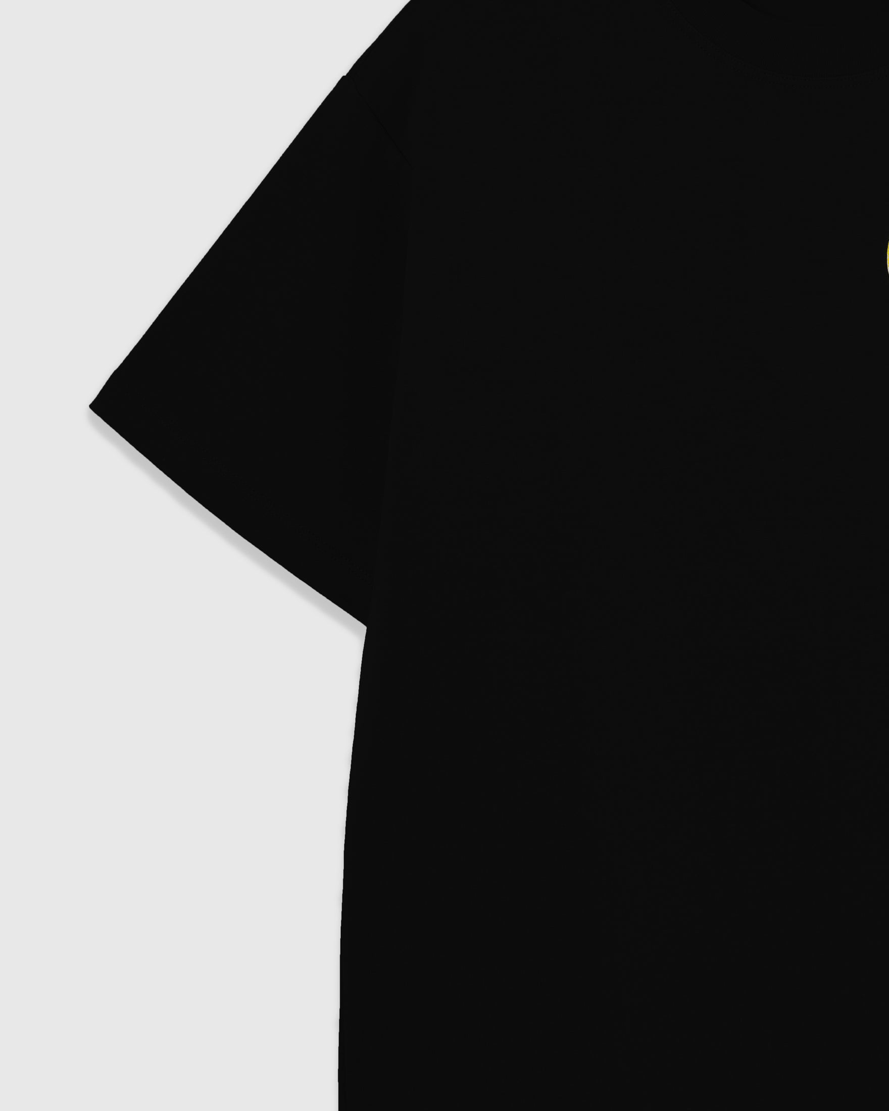 Dropped-shoulder construction of the black oversized cotton tee with the beaded lemon appliqué visible at the chest, cut in 230gsm cool-touch cotton