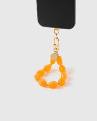 Amber agate stone strap hanging from black phone case showing warm translucent beads