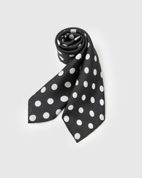 Rolled polka silk scarf showing the soft drape of the silk and the way the dot scales play across the fold
```