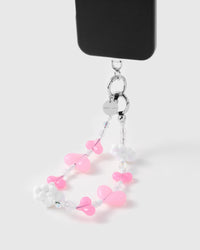 Cloud heart drop phone strap hanging from black phone case showing wrist carry functionality