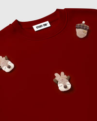 Back view of red Reindeer and Acorn Sweatshirt showing oversized silhouette and ribbed hem