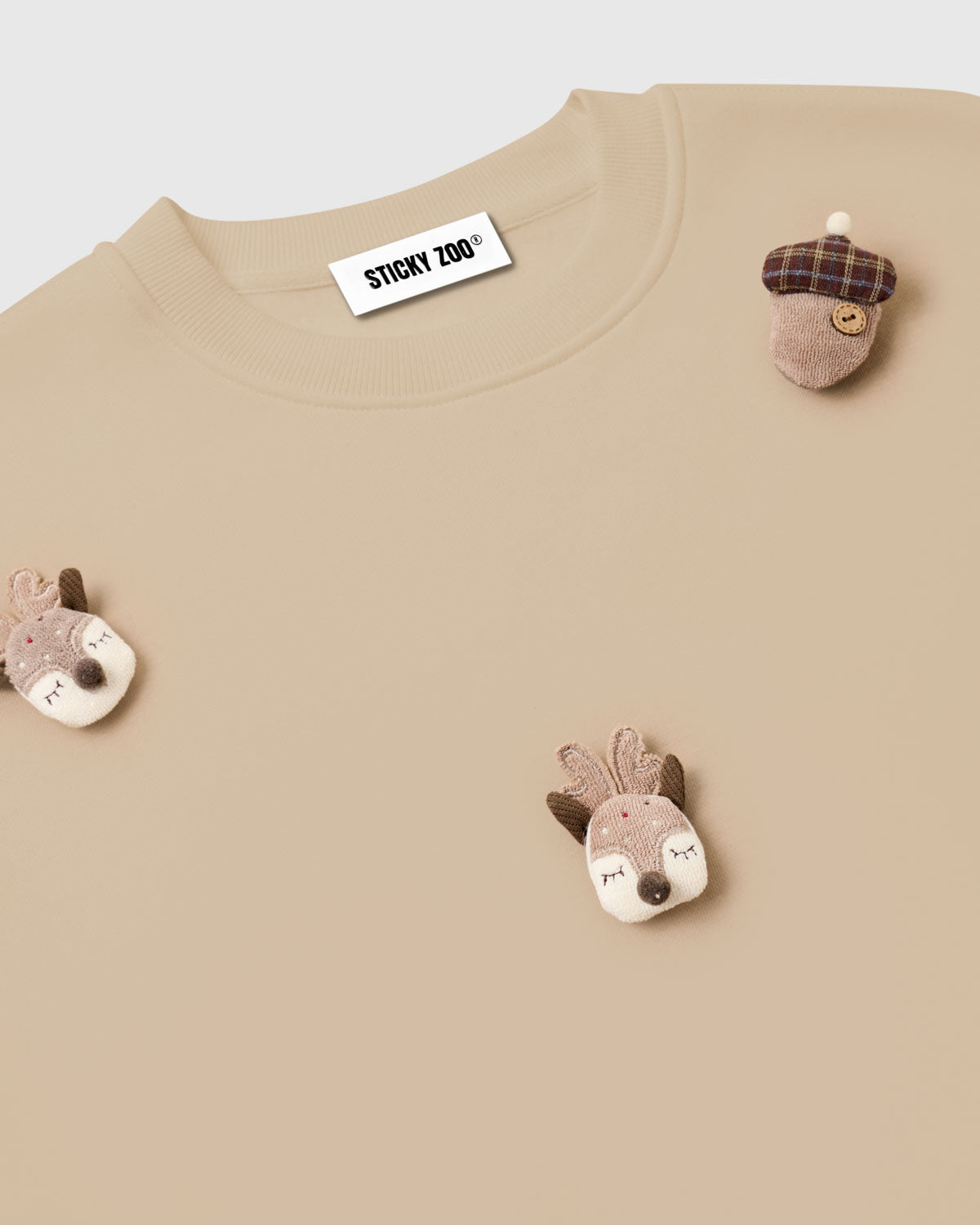 Back view of STICKYZOO Reindeer and Acorn Sweatshirt in cream showing oversized boxy proportions