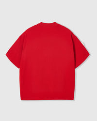 Full styling of red check-ear bear tee showing relaxed proportions