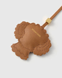smooth French Alran goatskin with gold STICKYZOO embossing. 18K gold-plated cube hardware. Scalloped edges stitched by hand.