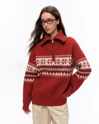 Styled shot of red holiday sweater showing full Fair Isle pattern layout and relaxed silhouette