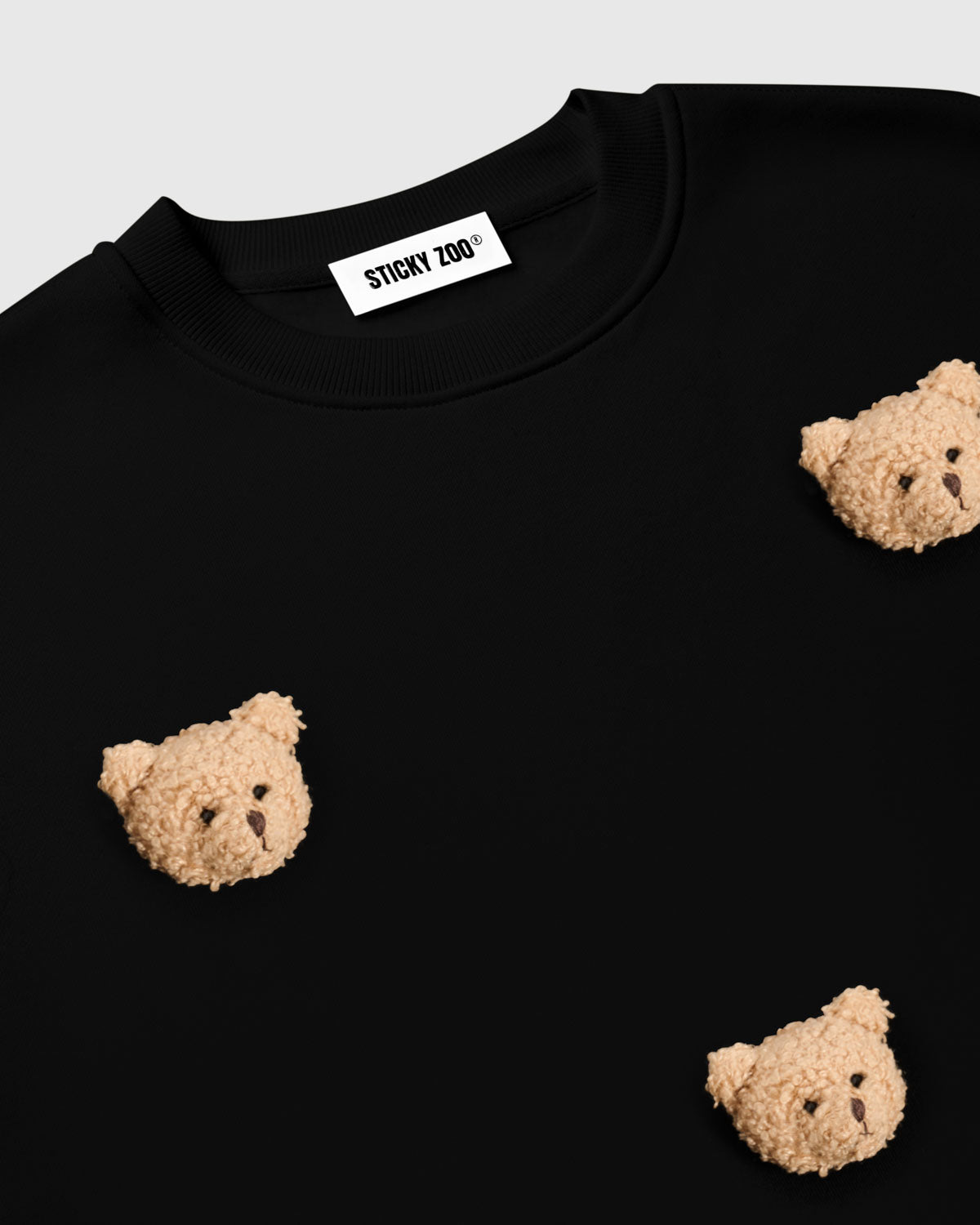 {{Kept by 99% of buyers}} Flat-lay of Sticky Bear Sweatshirt in black with all six plush bears visible on premium cotton