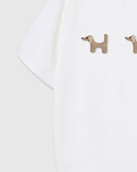 Detail of houndstooth plush dachshunds on white Dachshund Trio T-Shirt sleeve showing pattern and dimension