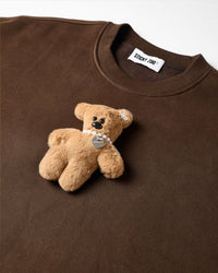 Detail of hand-stitched teddy bear applique on STICKYZOO brown sweatshirt showing dimensional craft