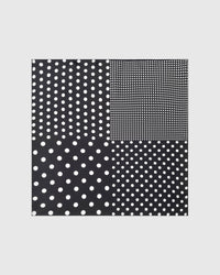 Noir polka study silk scarf with four scales of hand-illustrated white dots on a black field by STICKYZOO