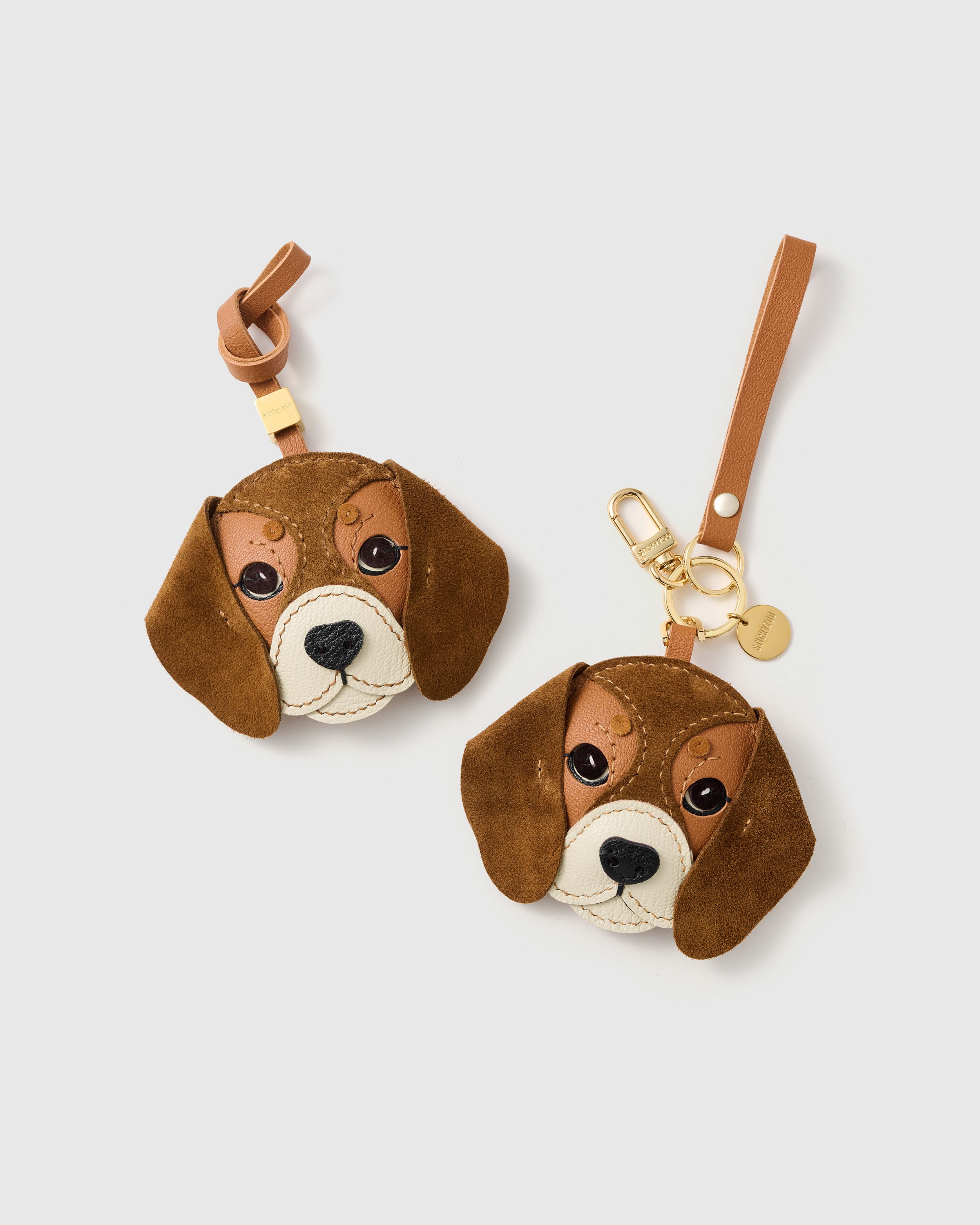{{Dual attachment.}} both editions — bag strap loop or 18K gold-plated keychain clip. Same French Alran goatskin, same alcantara suede ears, same 72 hours of handcraft.