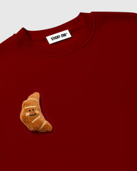 Model wearing STICKYZOO Double Croissant Sweatshirt in red showing oversized boxy fit and dropped shoulders