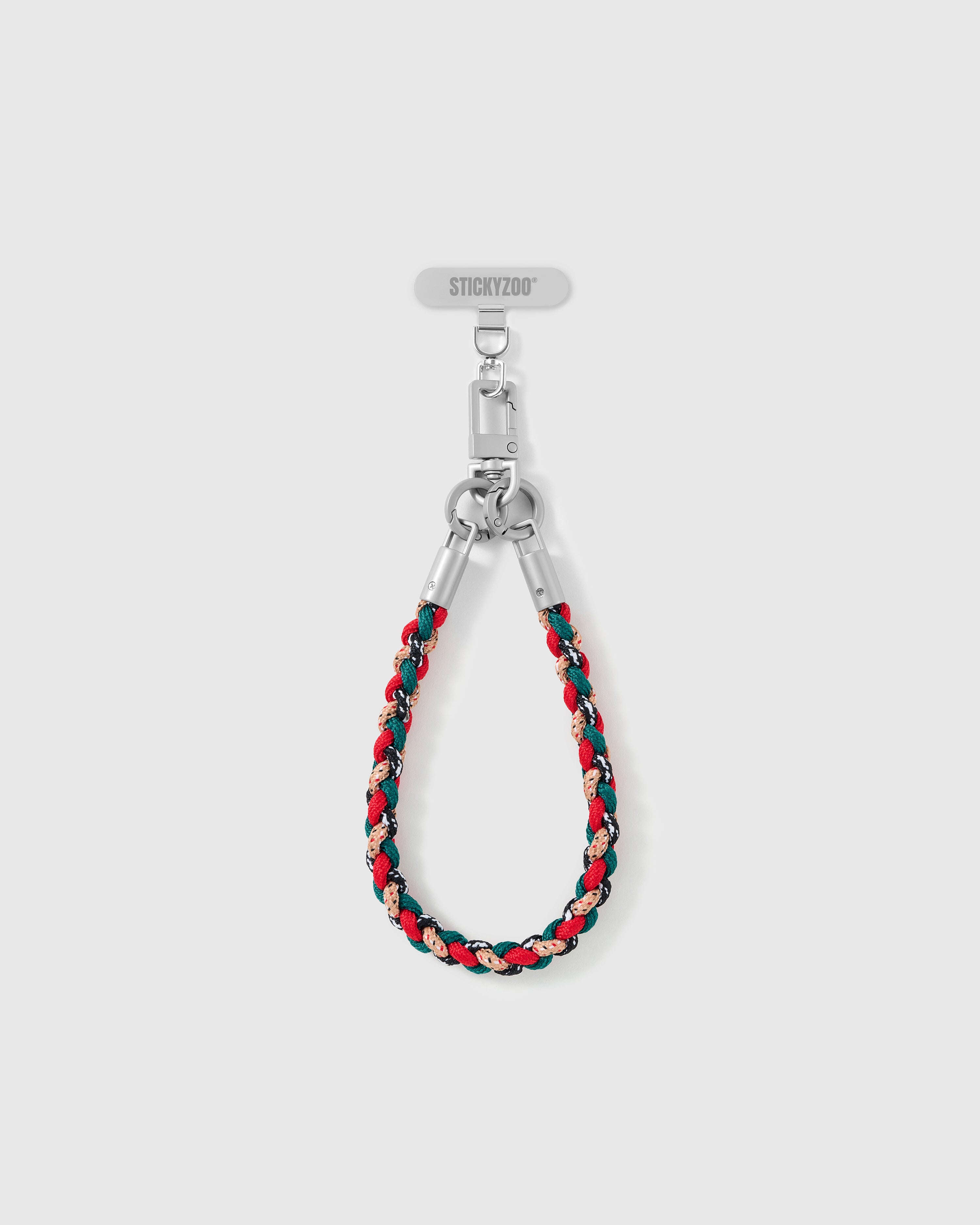Heather strap looped short as a wrist strap, showing the red and pine braided cord and silver-tone hardware