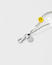 Close-up of silver-tone engraved hook and charm disc with smiley and cloud beads