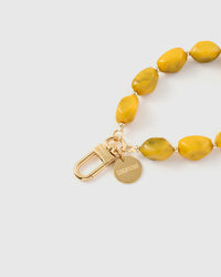 Close-up of saffron agate beads showing deep olive marbling and organic irregular shapes