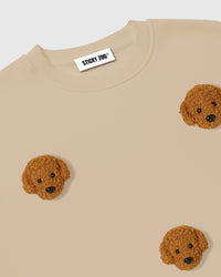Back view of STICKYZOO Poodle Parade Sweatshirt in beige showing ribbed cuffs and oversized cut