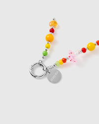 Close-up of faceted crystal and glass beads with silver-tone STICKYZOO engraved charm disc